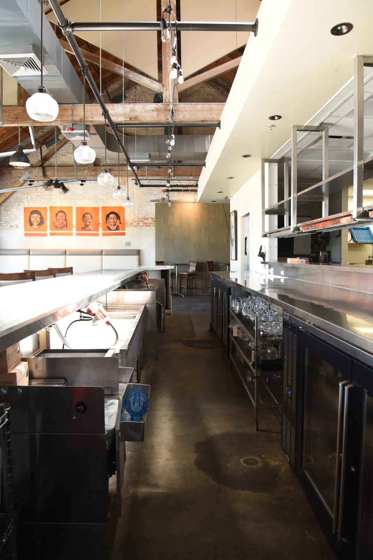 Interior view of the commercial bar setup at Press Street Station with stainless steel counters and overhead lighting